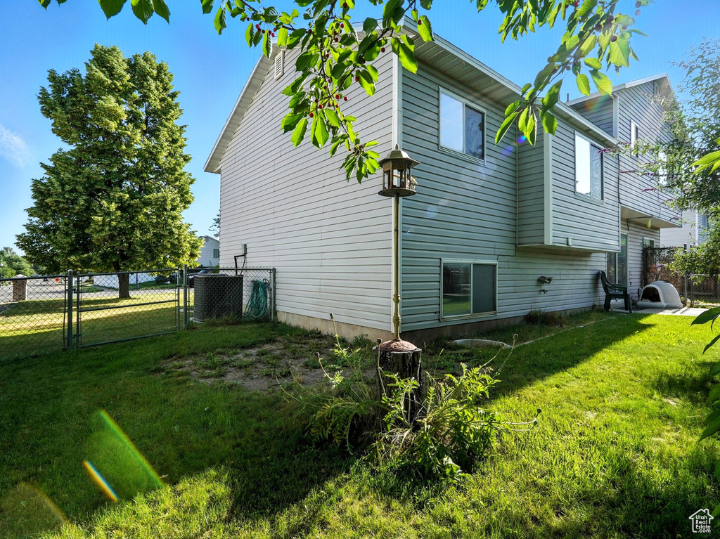 View of home's exterior featuring a gate and a central air condition unit