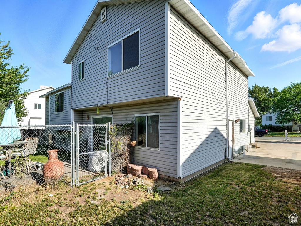 Rear view of property featuring a gate