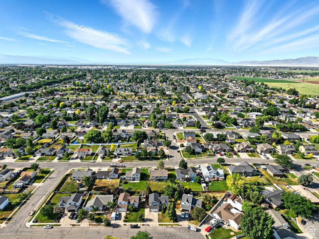 Aerial overview of property's location featuring mountains and nearby suburban area