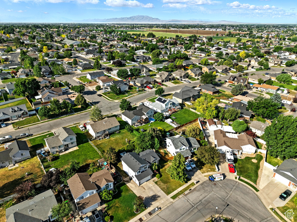 Aerial view of property's location featuring nearby suburban area and a mountain backdrop