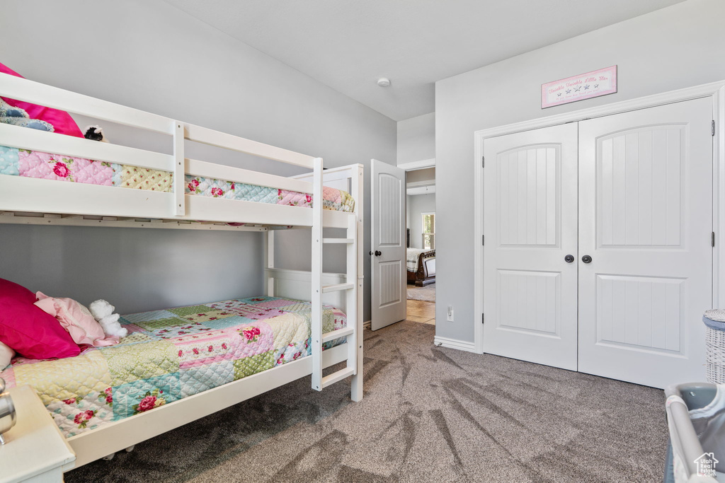 Carpeted bedroom featuring a closet