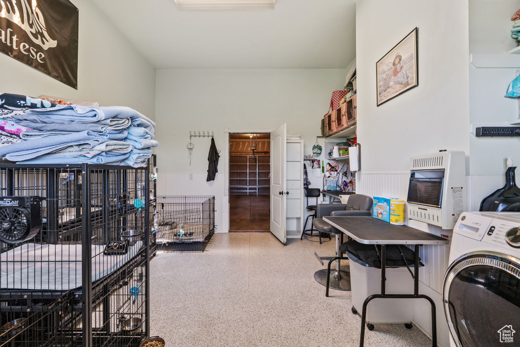 Laundry area with heating unit and washer / dryer