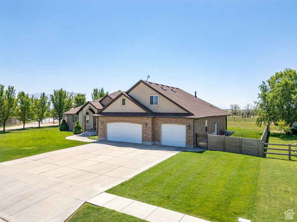 View of front of home with concrete driveway, a garage, brick siding, and stucco siding