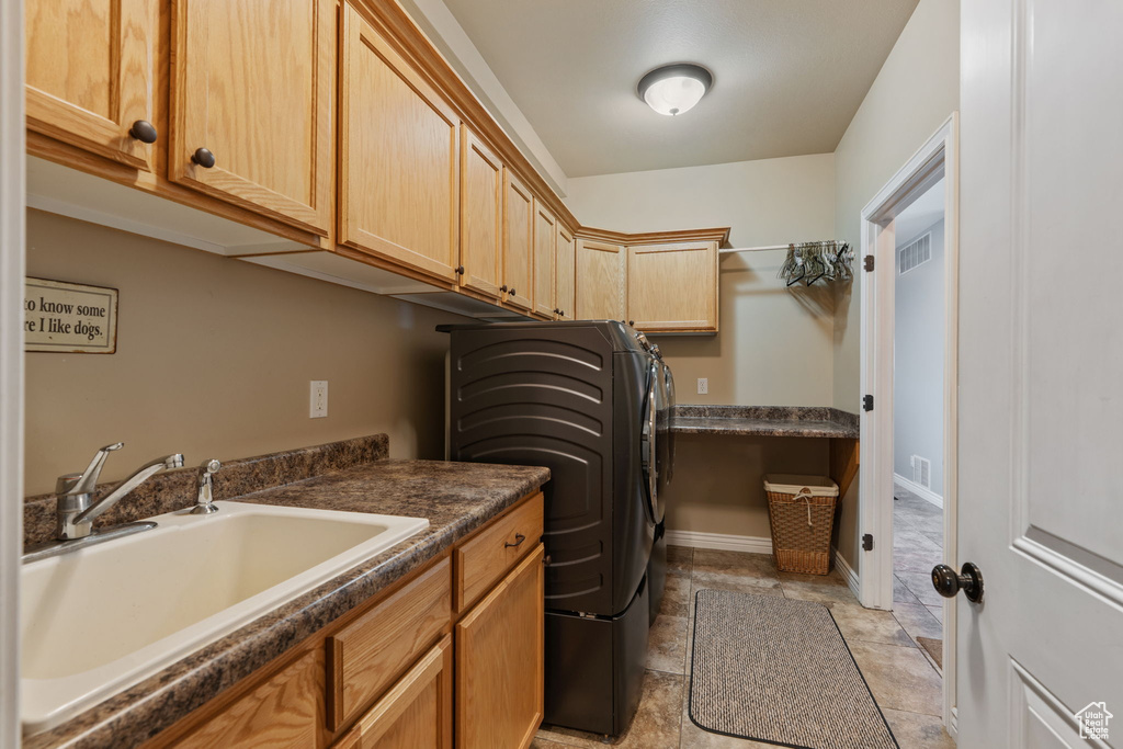 Laundry area featuring cabinet space and washer and clothes dryer