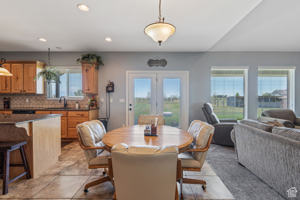 Dining space with recessed lighting and light tile patterned floors