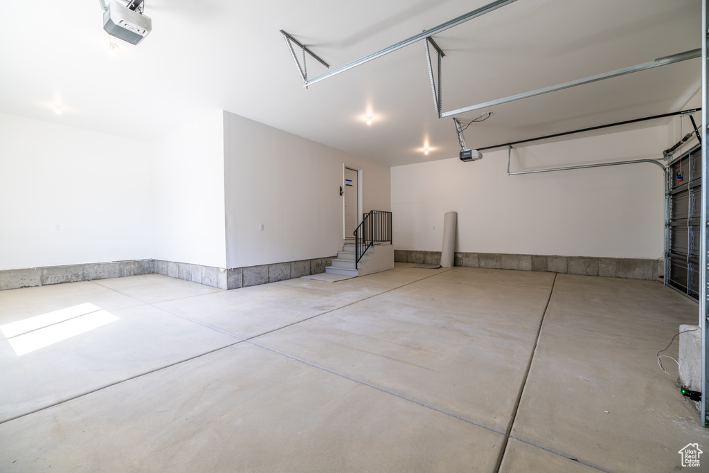 Garage featuring a garage door opener