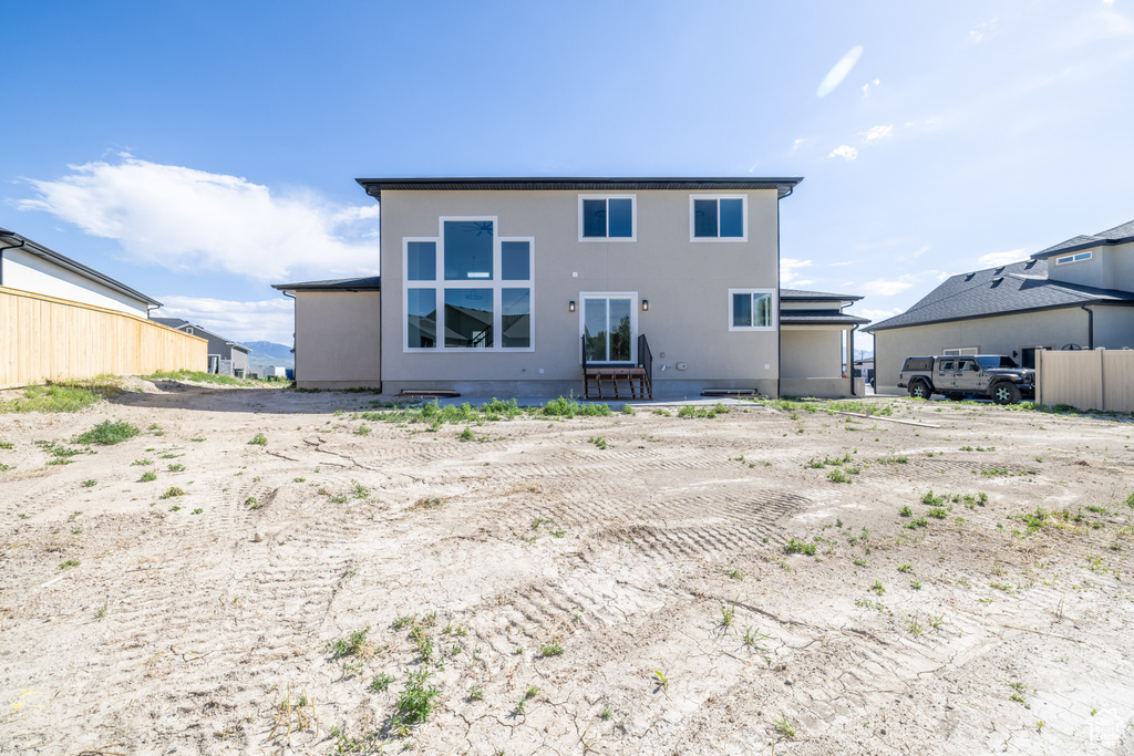 Rear view of house with stucco siding
