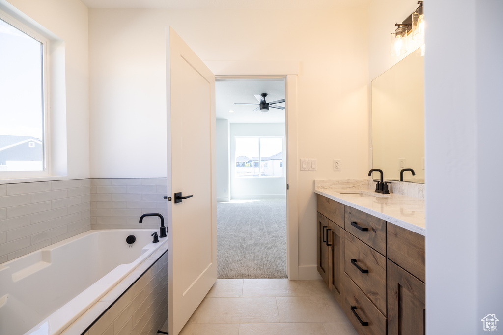 Full bath featuring vanity, a bath, tile patterned floors, and ceiling fan