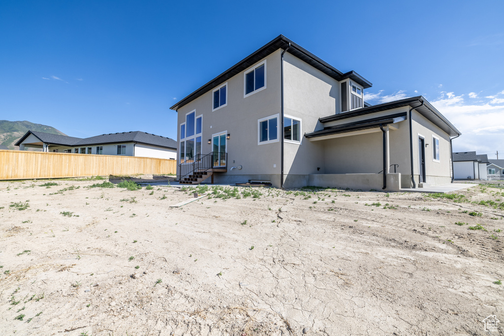 Back of property featuring stucco siding