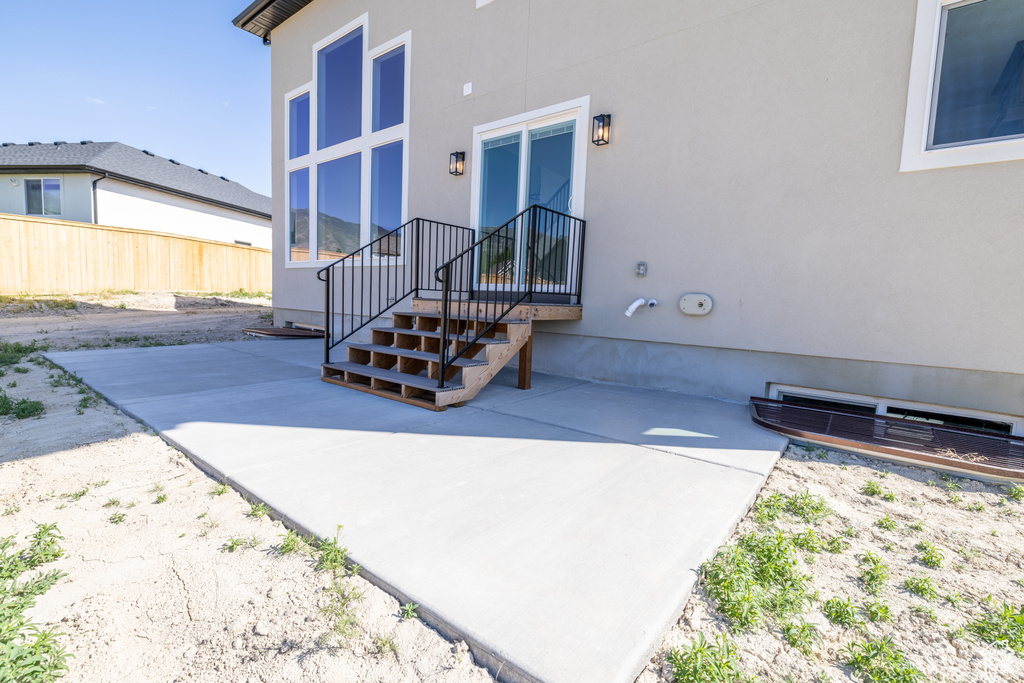 Doorway to property with stucco siding and a patio area