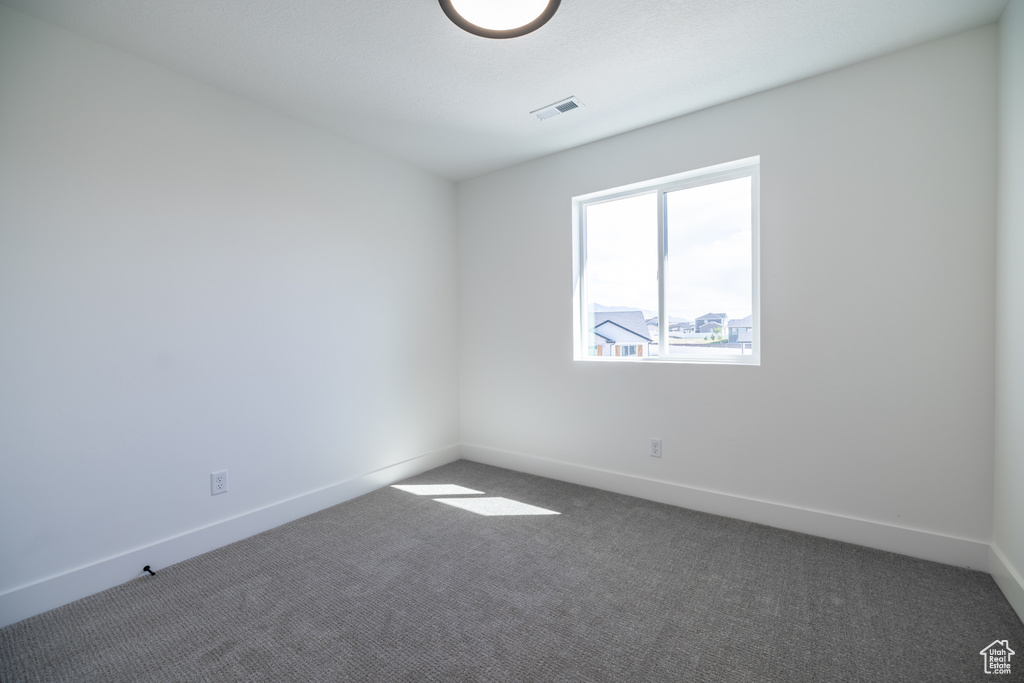 Unfurnished room with carpet flooring and baseboards