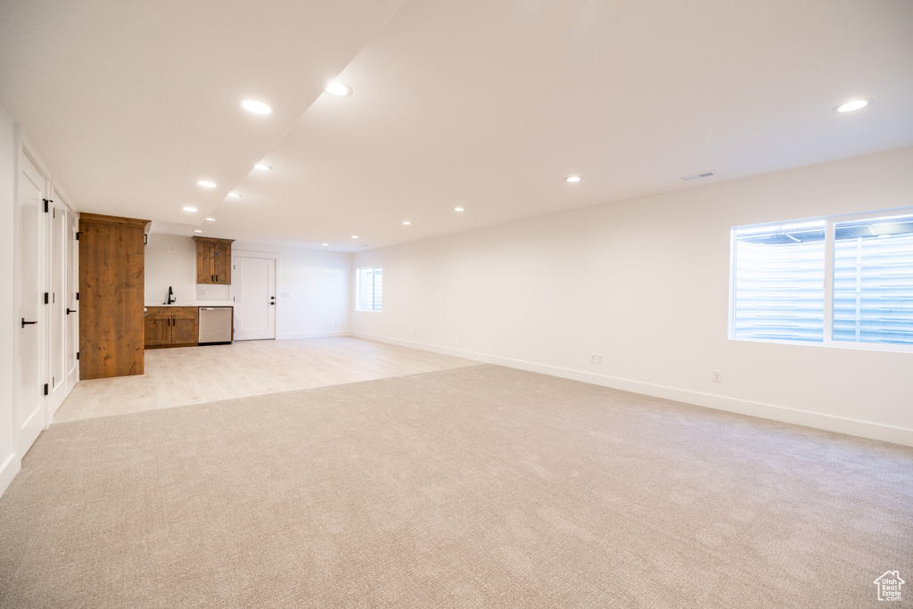 Basement featuring light colored carpet and recessed lighting