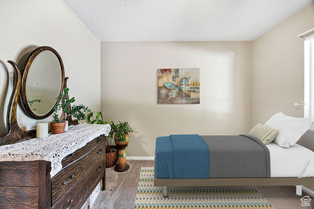 Carpeted bedroom featuring baseboards
