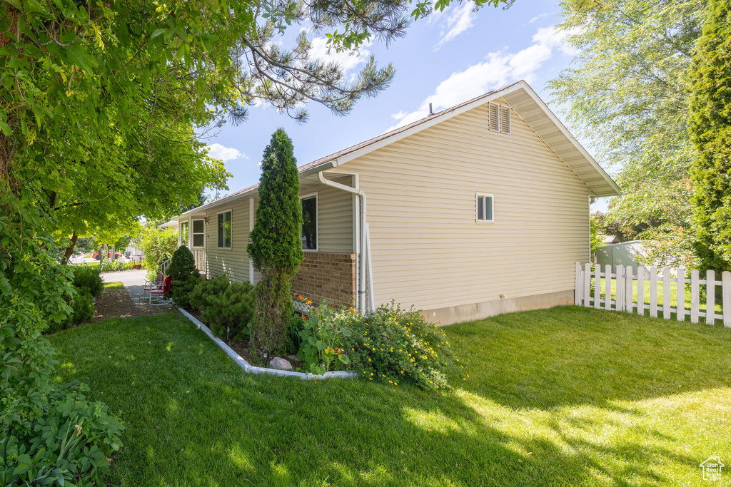 View of property exterior with brick siding