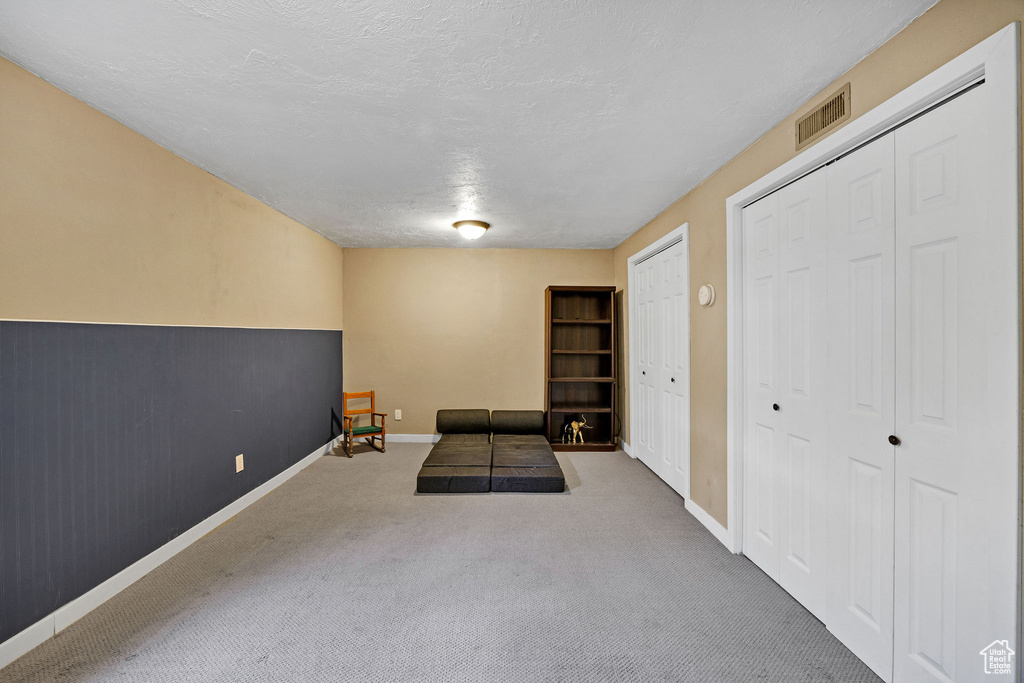 Workout area with carpet and a textured ceiling