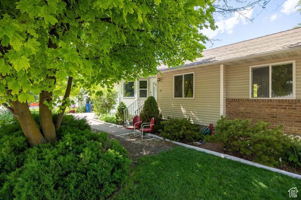 View of front of property with brick siding and roof with shingles