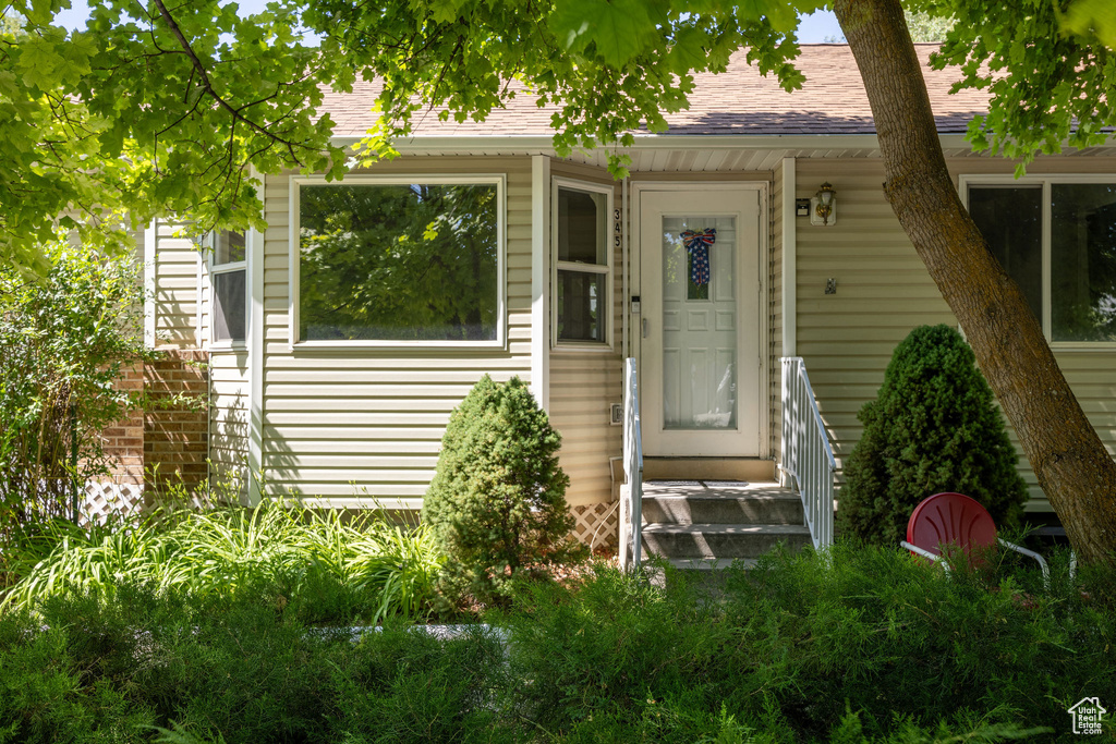 Property entrance with a shingled roof