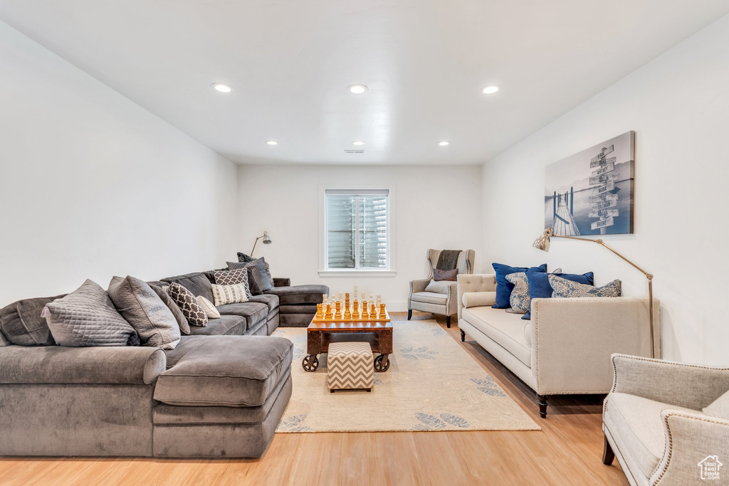 Living room with wood finished floors and recessed lighting