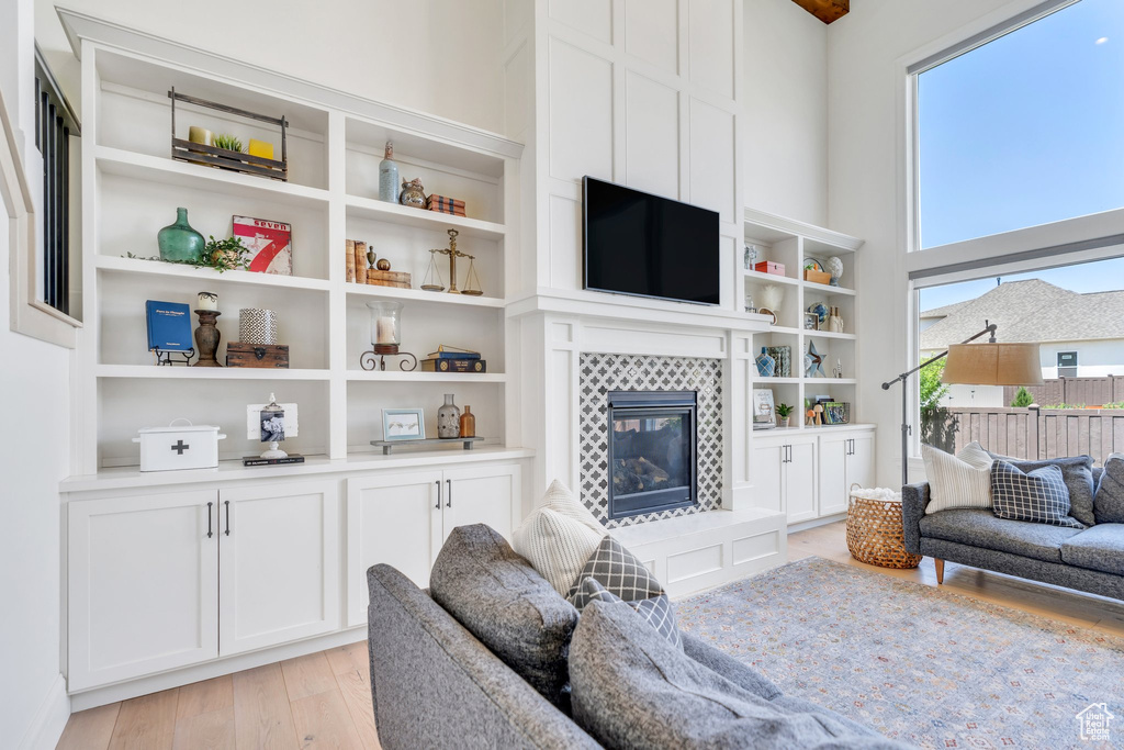 Living room with light wood-type flooring and a fireplace