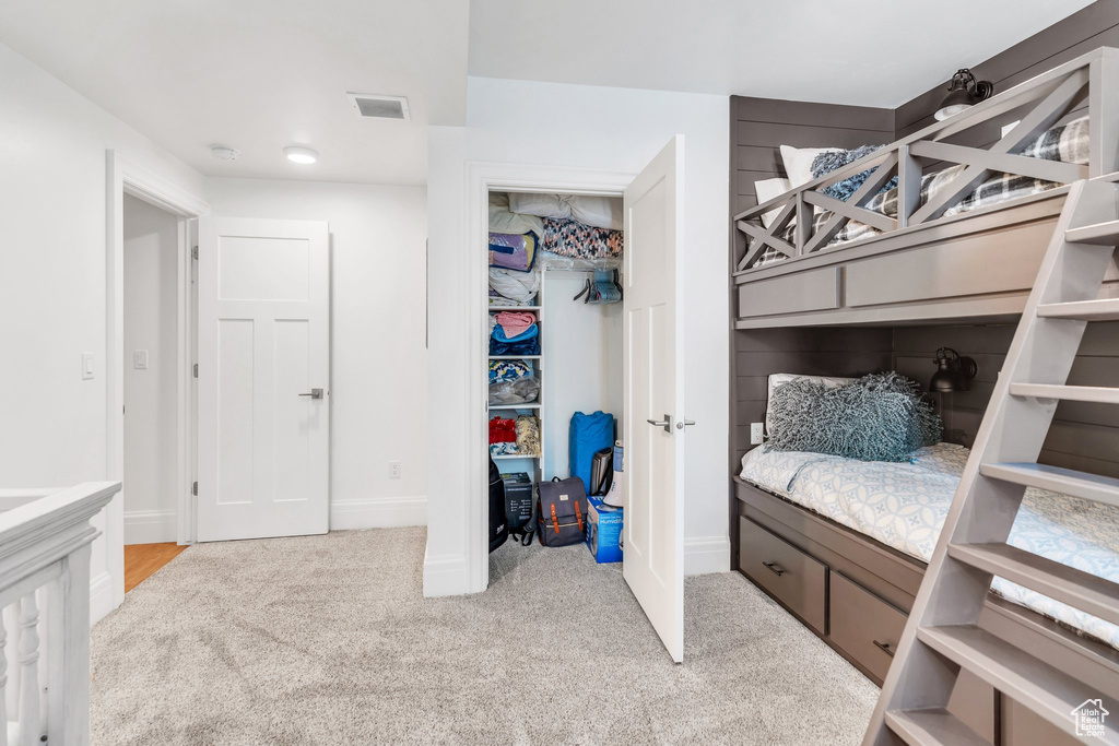 Carpeted bedroom with baseboards and a closet