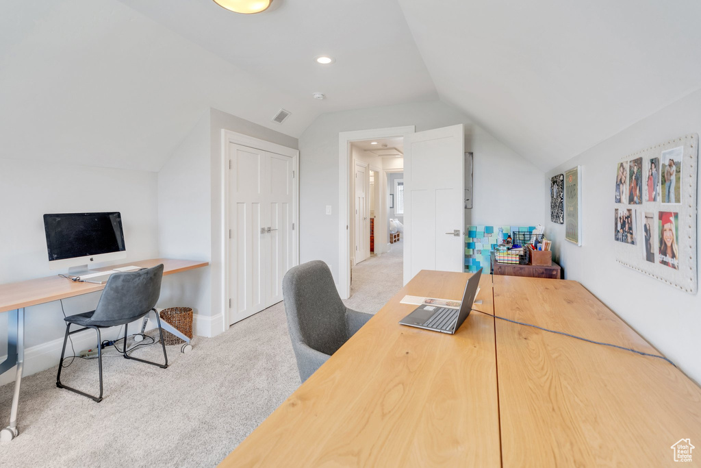 Carpeted office featuring vaulted ceiling