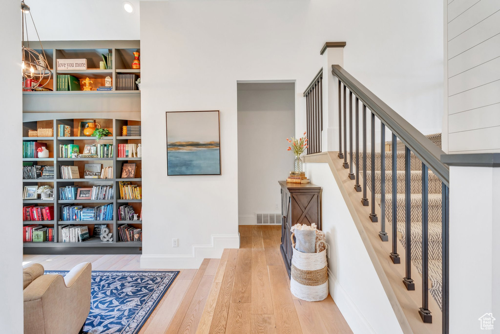 Stairs with wood finished floors and baseboards