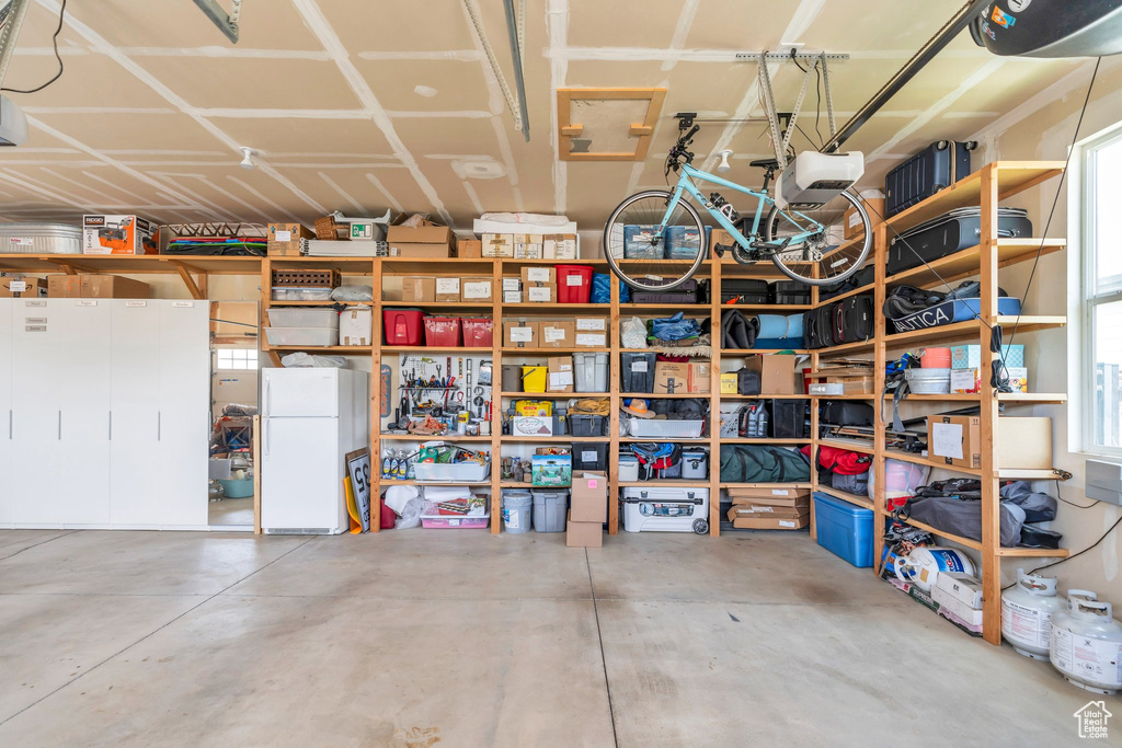 Garage featuring freestanding refrigerator