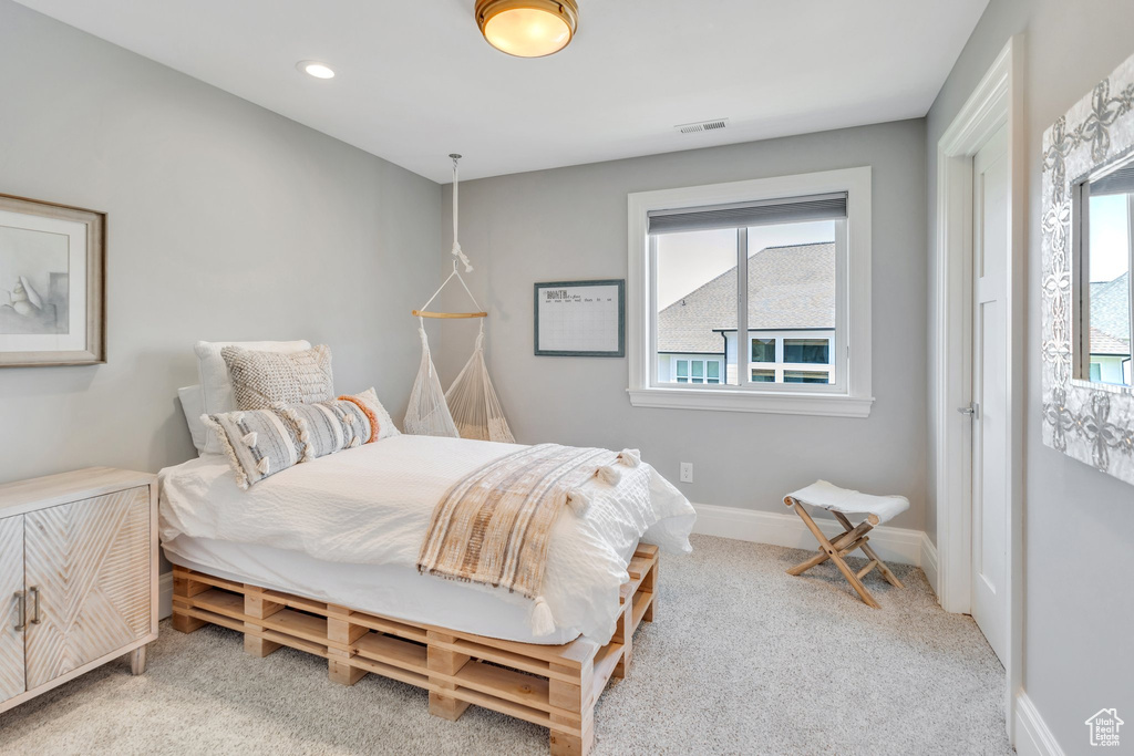 Carpeted bedroom featuring baseboards