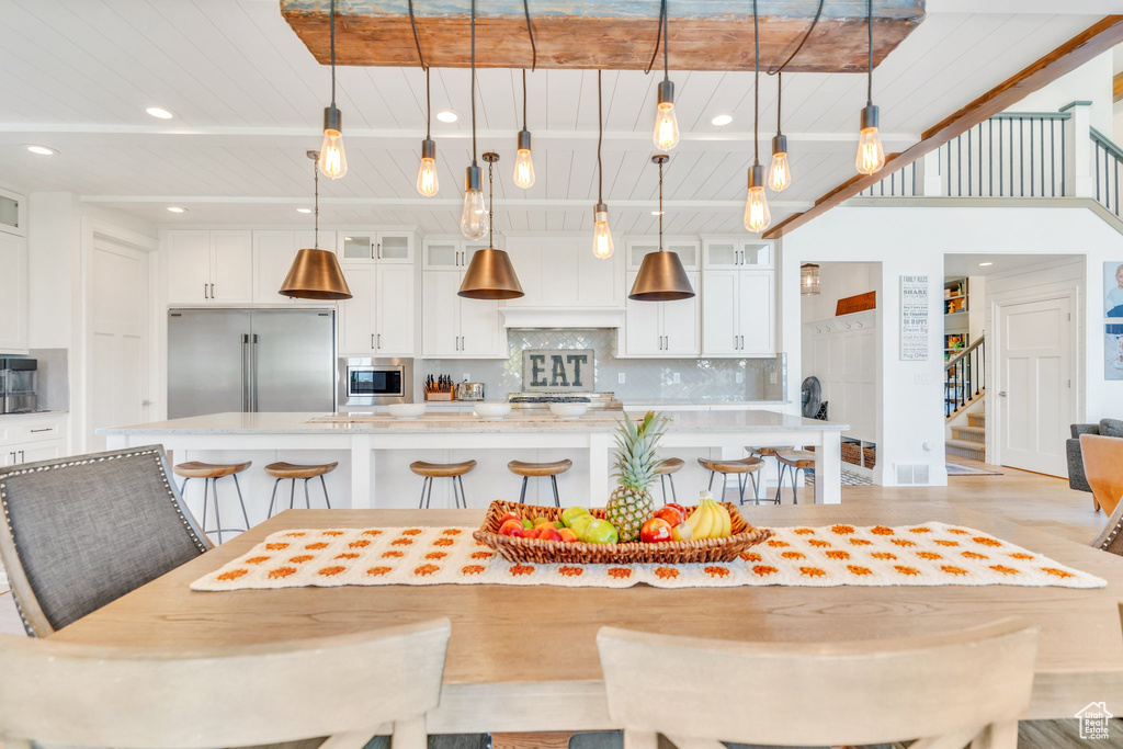 Dining room featuring stairs, recessed lighting, and light wood-type flooring