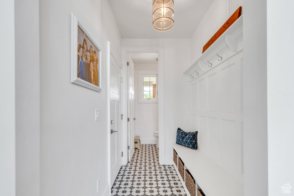 Mudroom featuring light flooring and baseboards