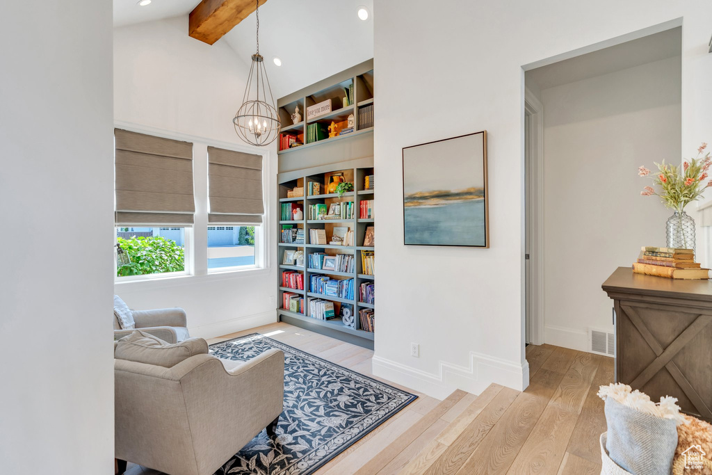 Living area with wood finished floors, recessed lighting, and a chandelier