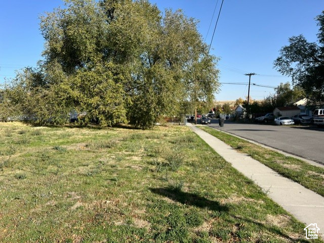View of asphalt road featuring sidewalks