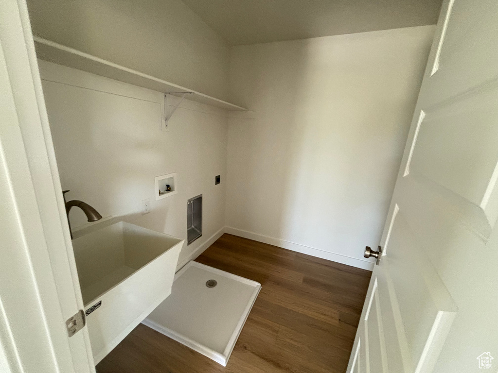 Laundry area with dark wood-style flooring, electric dryer hookup, and hookup for a washing machine