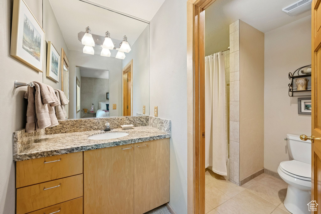 Full bath with vanity, tile patterned floors, and curtained shower