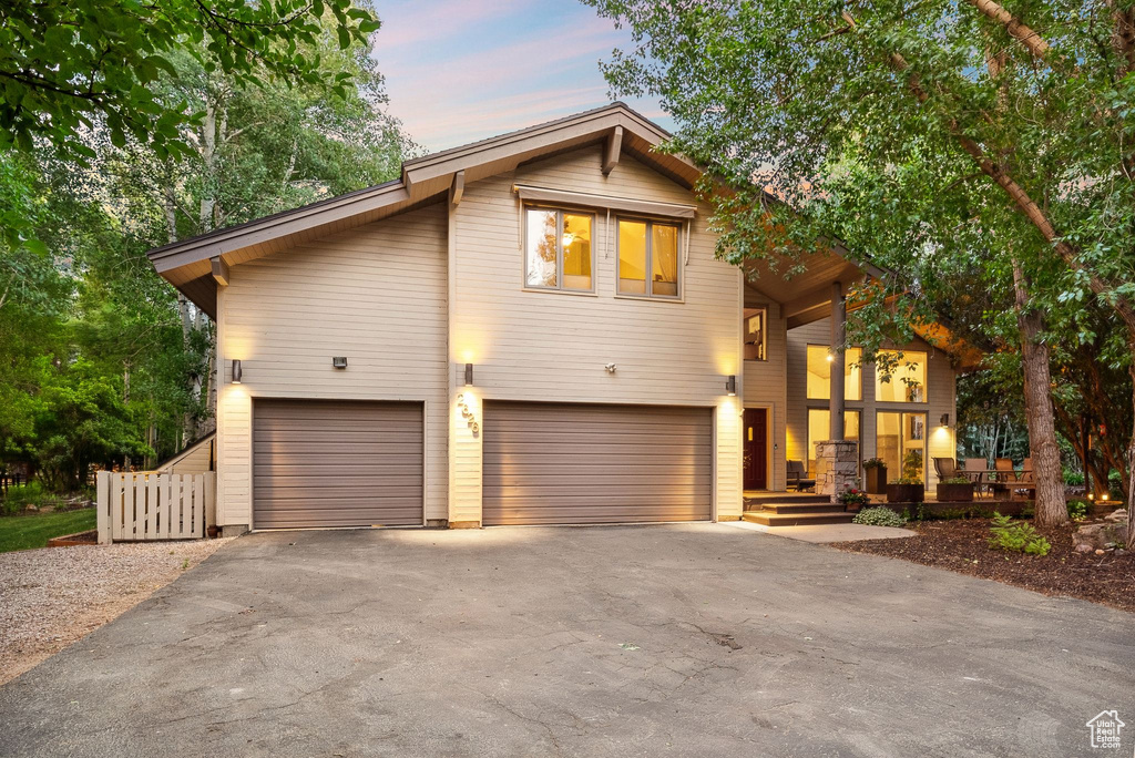 View of front of property featuring a garage and driveway