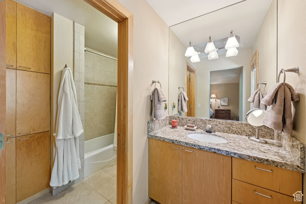 Full bathroom featuring vanity, ensuite bath, tile patterned flooring, and shower / tub combination