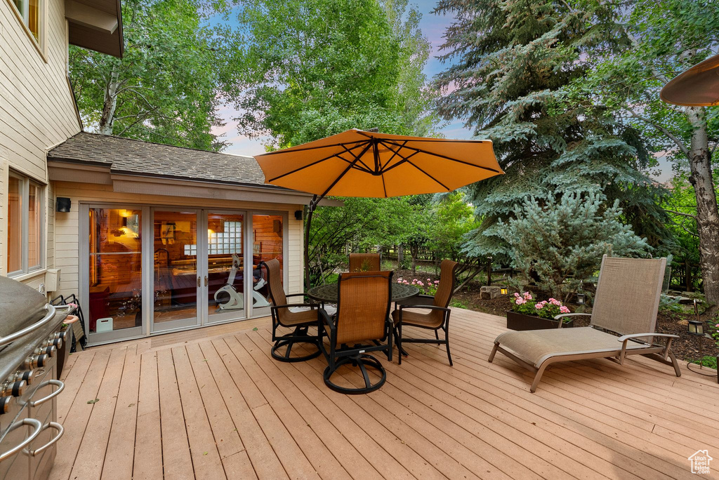 Deck at dusk featuring outdoor dining area