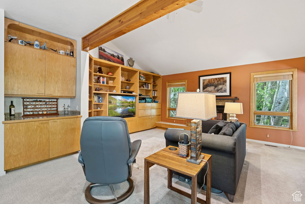 Living area featuring light colored carpet and baseboards