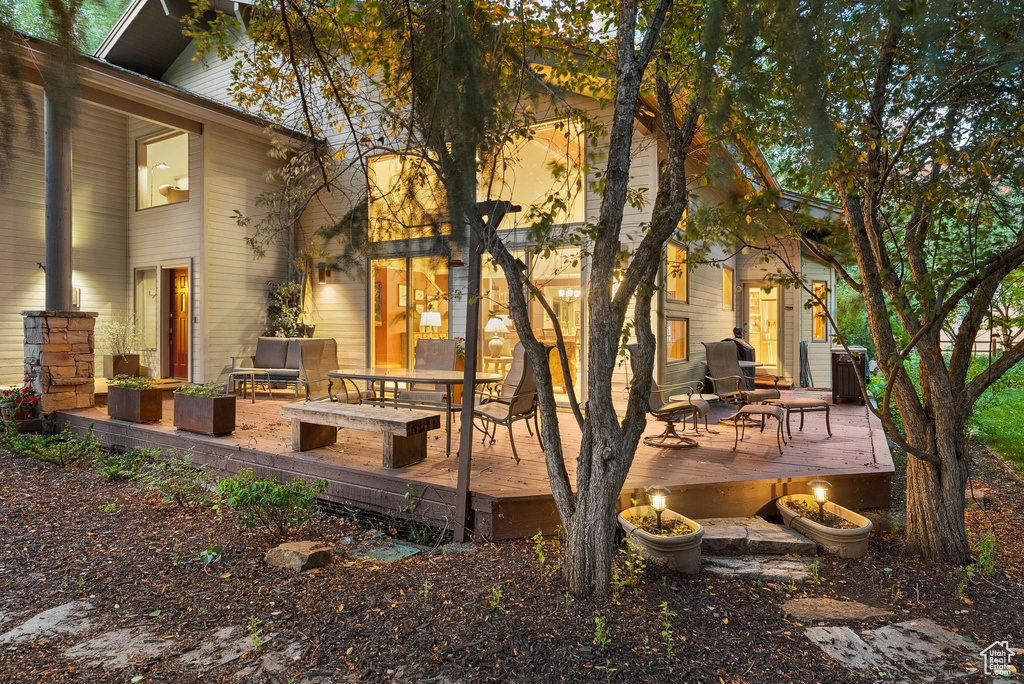 Back of house with a deck and an outdoor hangout area