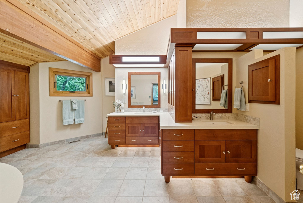 Bathroom with lofted ceiling, double vanity, and wooden ceiling