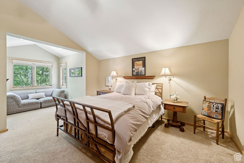 Bedroom with carpet and lofted ceiling
