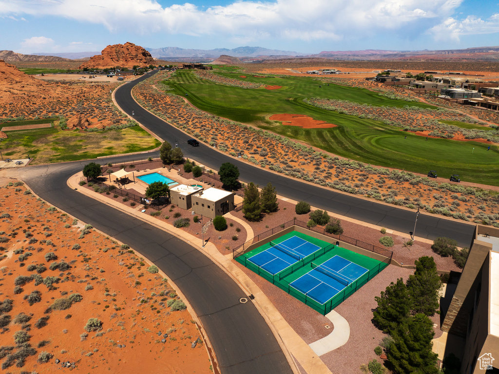 Aerial view of a mountainous background and a golf course