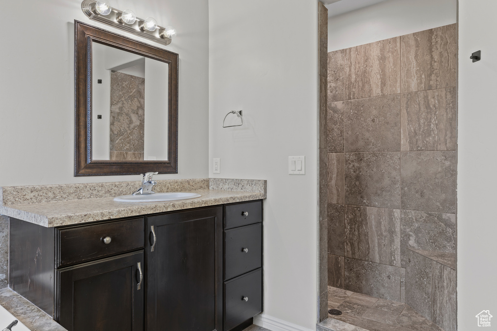 Full bathroom featuring vanity and a tile shower