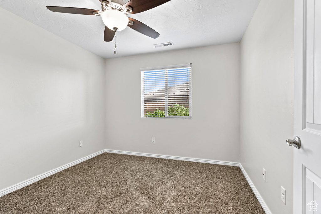 Spare room with carpet flooring and ceiling fan