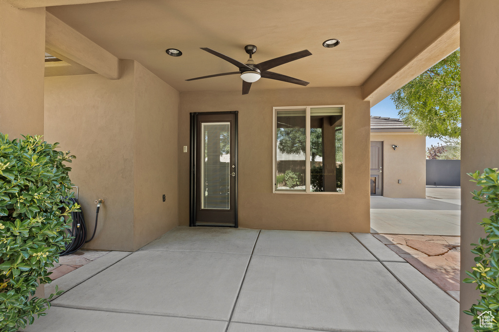 Property entrance featuring a ceiling fan, stucco siding, and a patio area