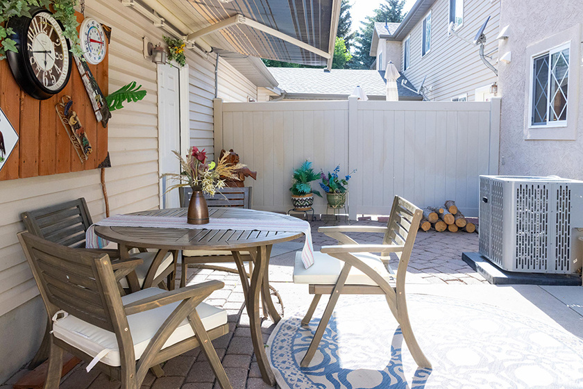 Fenced backyard with a patio and outdoor dining area