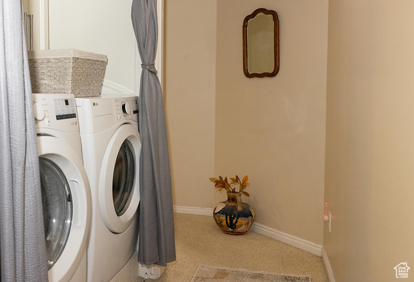 Laundry area featuring separate washer and dryer and carpet flooring