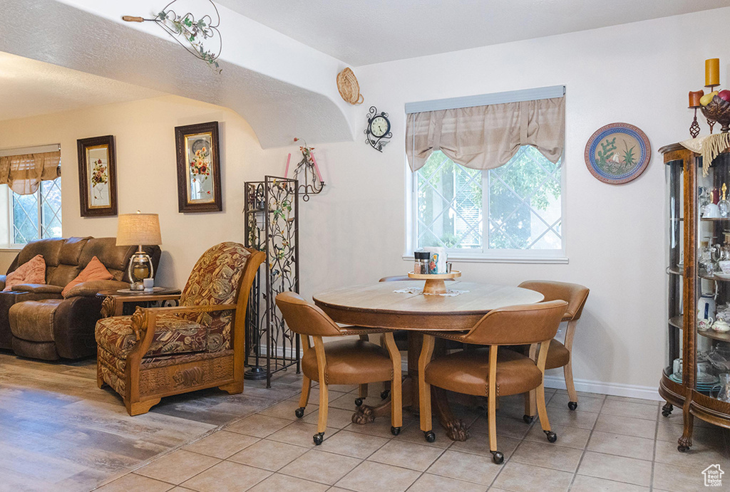 Dining room featuring light tile patterned flooring and baseboards