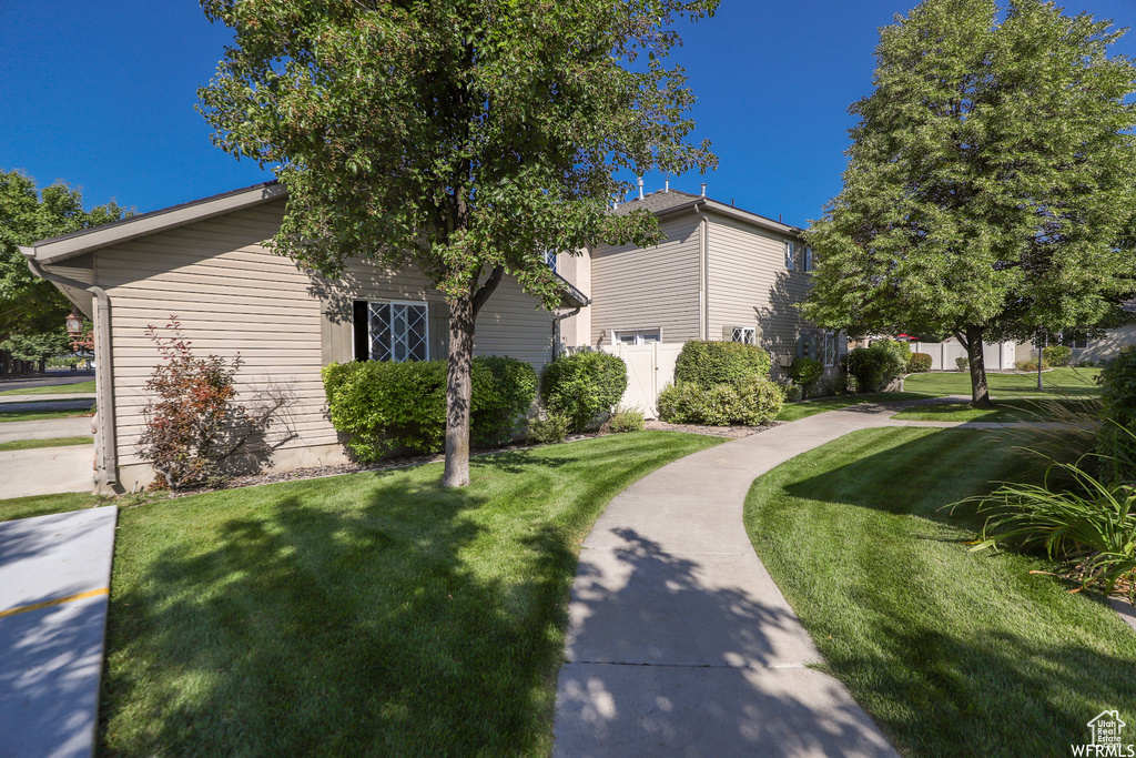 View of side of home featuring a yard