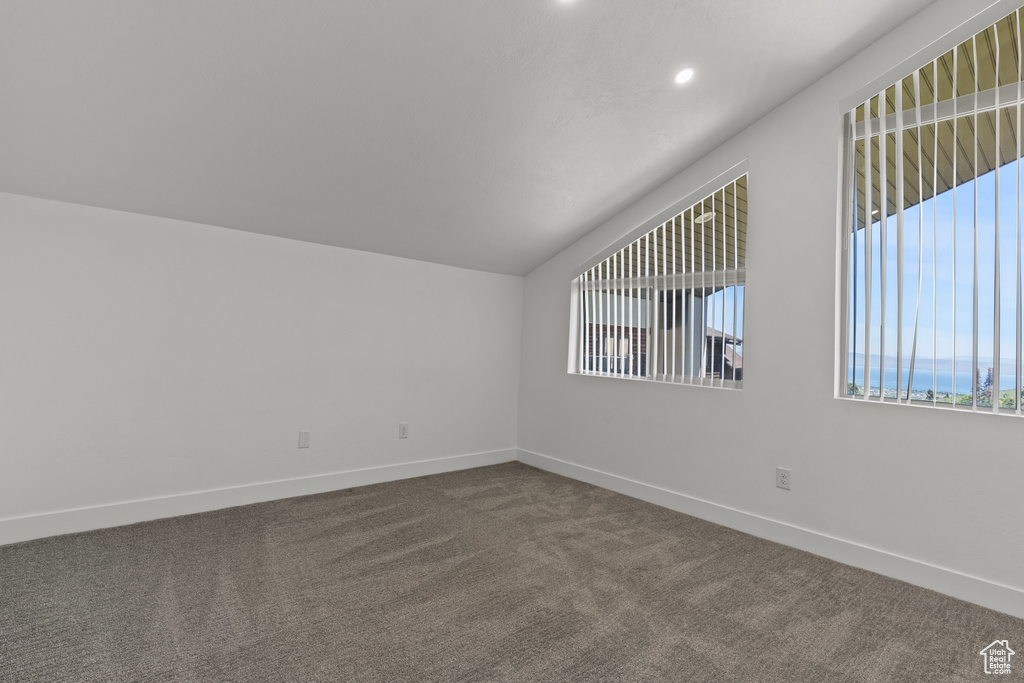 Bonus room with dark colored carpet, recessed lighting, and lofted ceiling